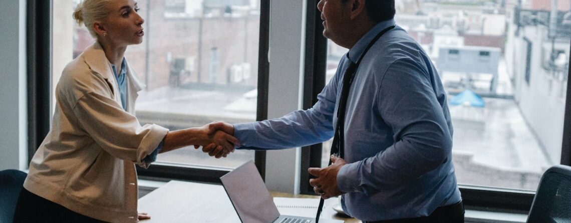 Woman shaking hands with her employer