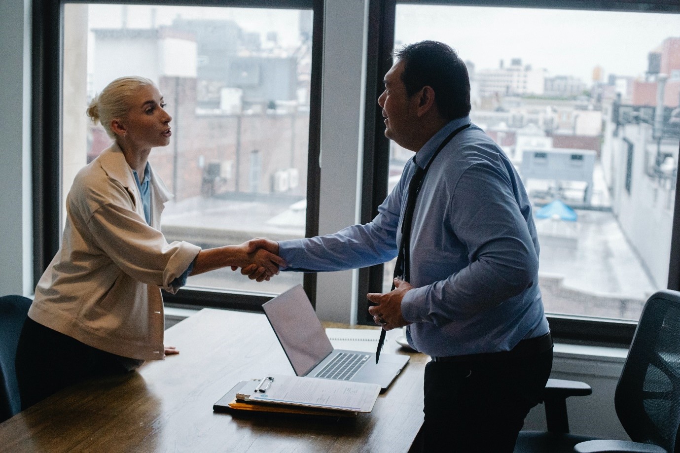 Woman shaking hands with her employer