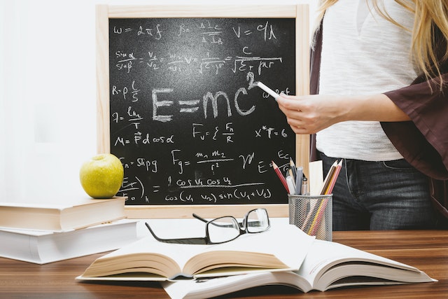 A woman illustrating Albert Einstein’s equation